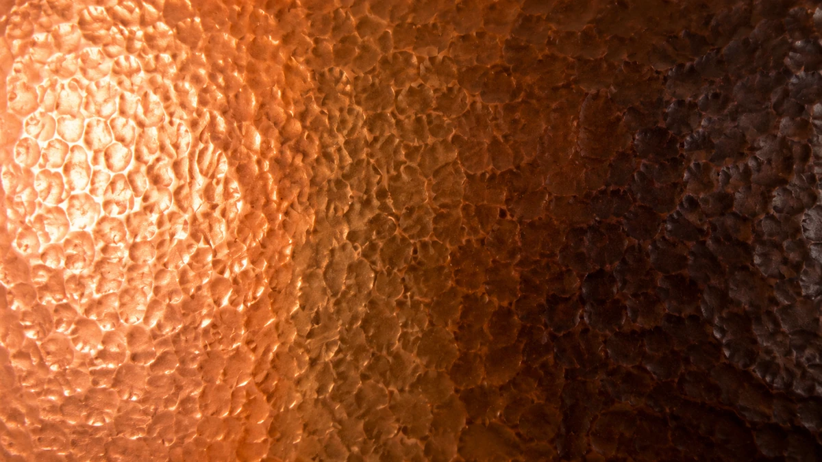 The natural evolution of copper patina from bright metal to deep bronze.